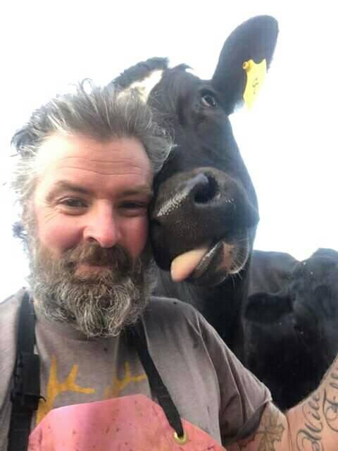 Pictured: Unnamed farmer and cow showing thanks for donations.